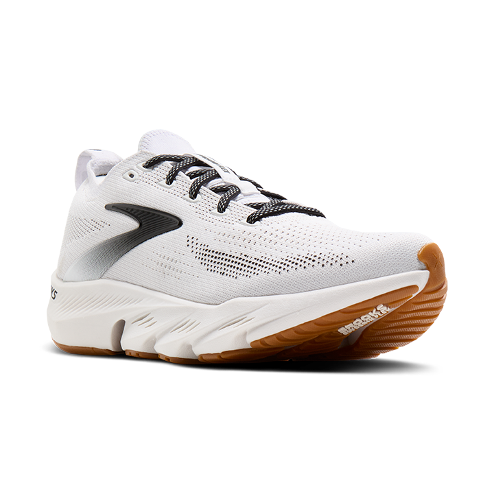 White running shoe with brown sole on a white background