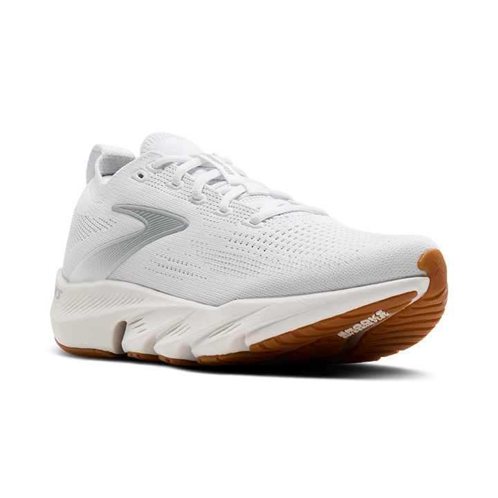 White athletic shoe with brown sole on a white background